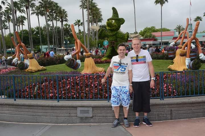 My husband and I at Disney's Hollywood Studios by the Beauty and the Beast statue.