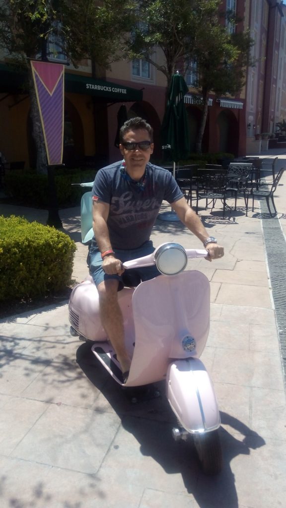 Stuart on a Vespa outside Portofino Bay Hotel