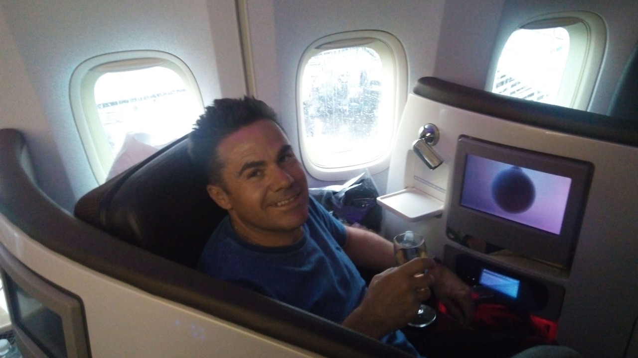 Me in my Upper Class seat with champagne in Orlando