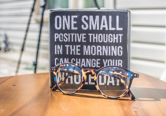 photo of a sign and eyeglasses on table