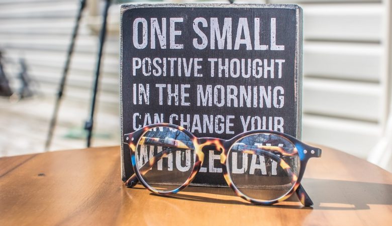 photo of a sign and eyeglasses on table